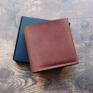 Personalized wallet with 2 banknote compartments, 3 card slots, and a coin pocket, made of light brown leather with engraving names, initials etc