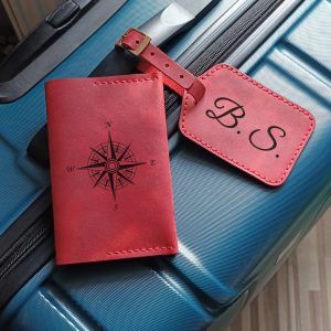 Personalized gift travel set with a luggage tag and passport cover, handmade from high-quality red leather, customizable with names or initials.